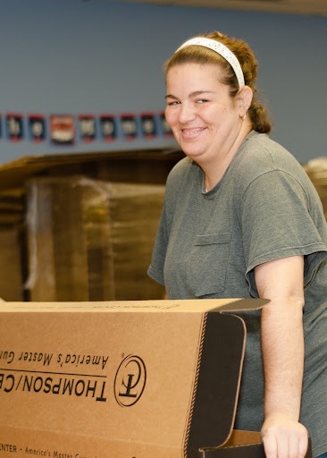 Packing, sorting, assembly, and other contract services work puts smiles on faces and money in the pockets of people with disabilities (photo courtesy of Paige Connors, American Training, Inc.)